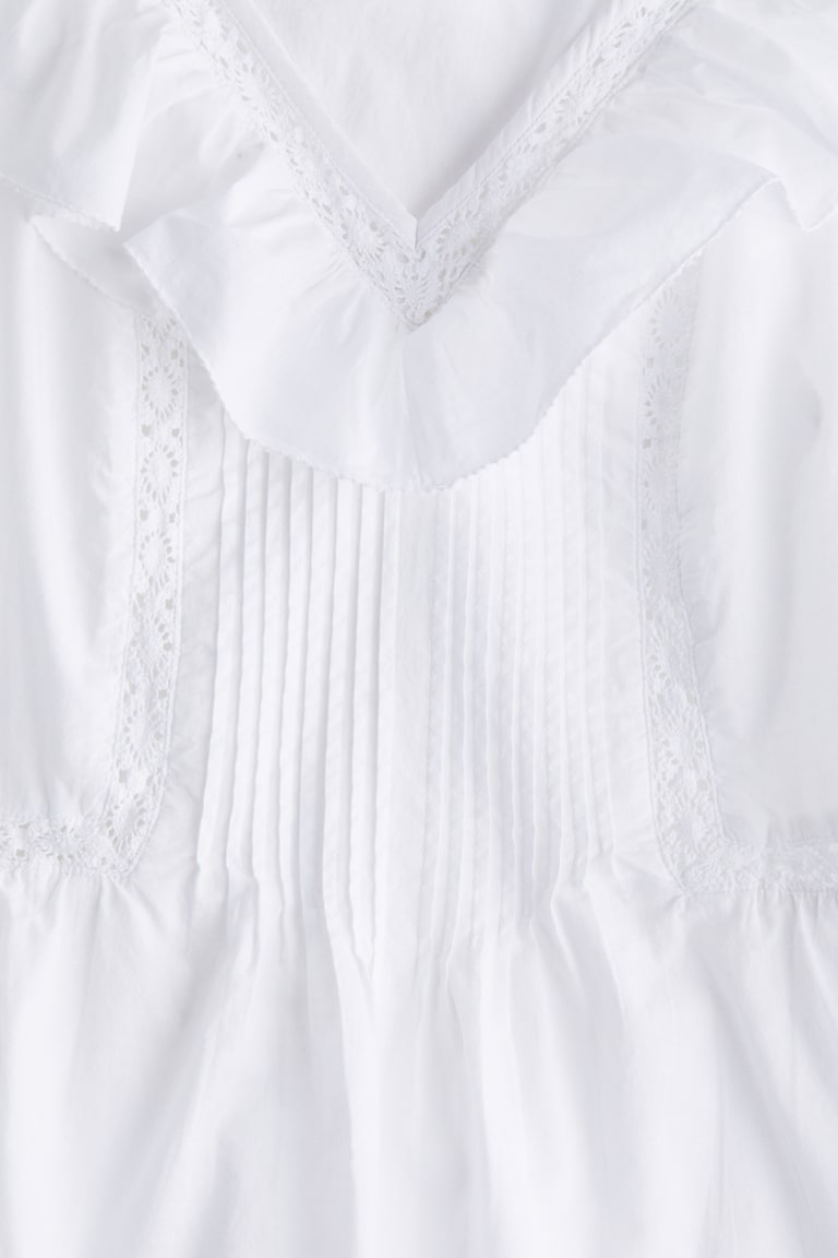 H&M Baumwolltop mit Volant Rabatte dieses Monats